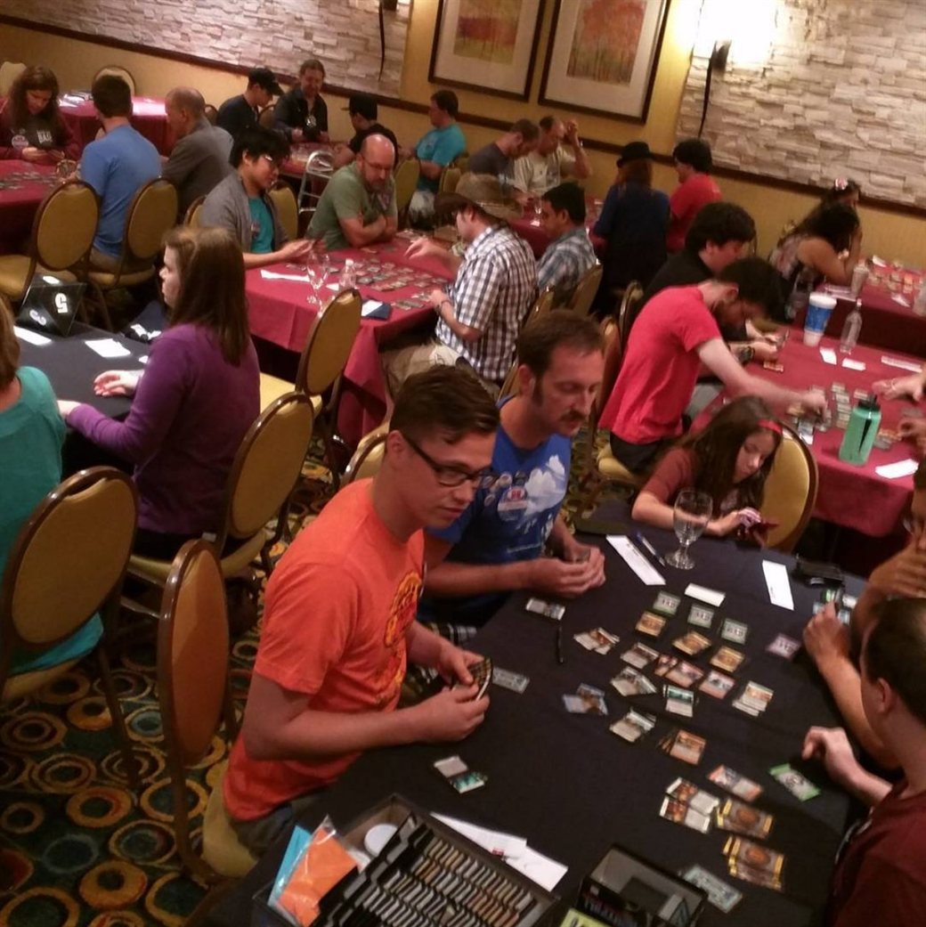 Players filling a hotel ballroom at banquet tables during a card game tournament at the 2015 Bash